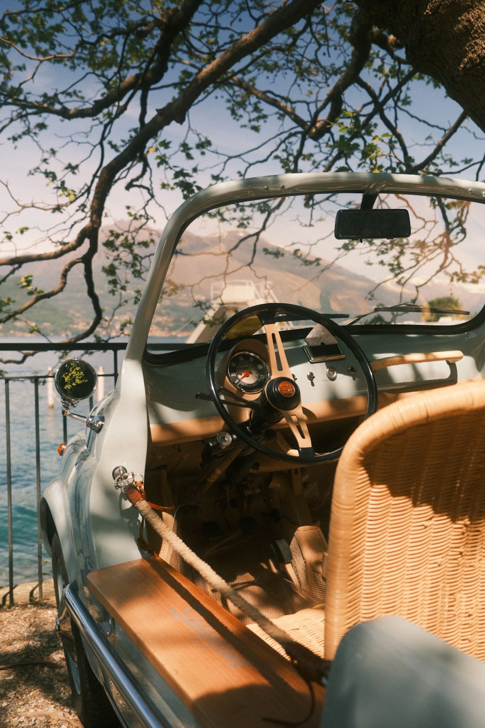the interior of a car with a view of the water