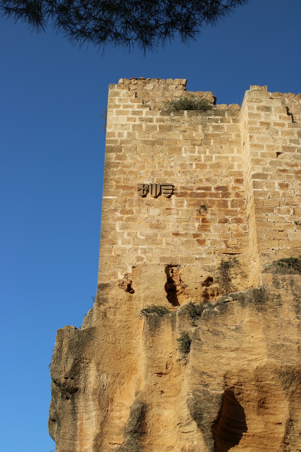 a tall brick tower with graffiti on the side of it