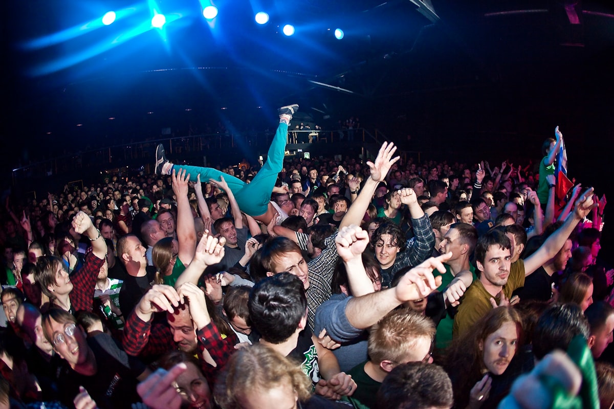 Live entertainment event with large audience and stage lighting