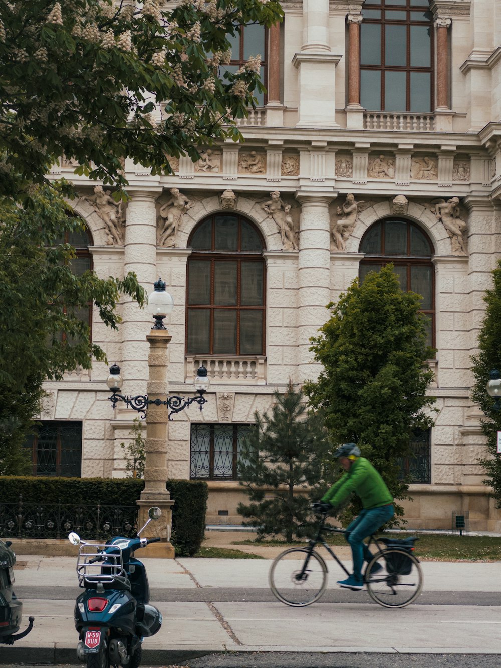 a man riding a bike next to a scooter