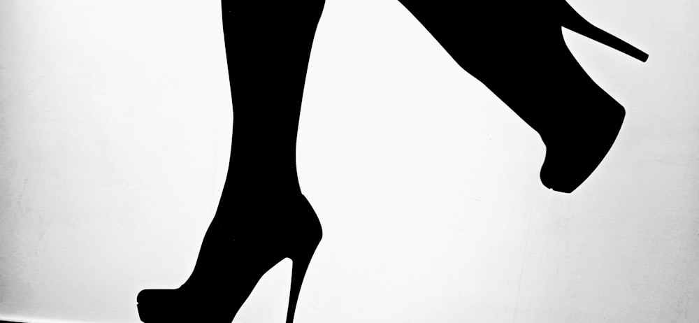 a black and white photo of a high heeled shoe