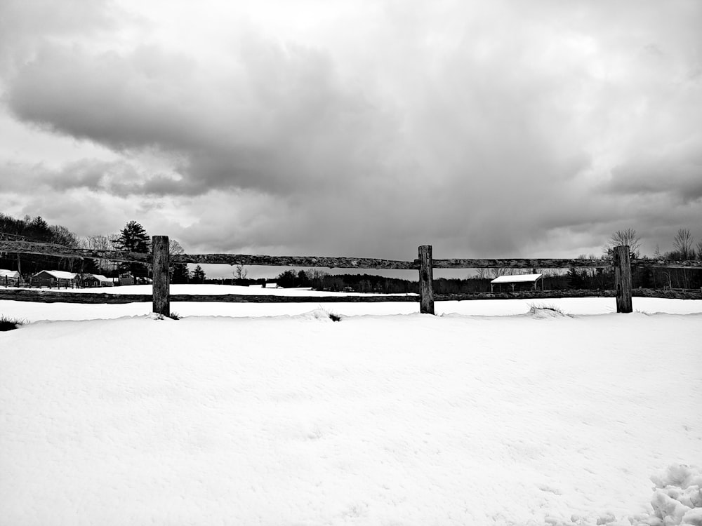 a black and white photo of a snow covered field