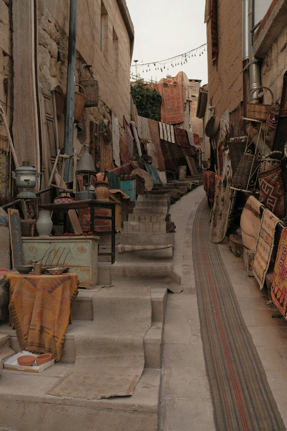 a narrow street with a bunch of items on the sidewalk
