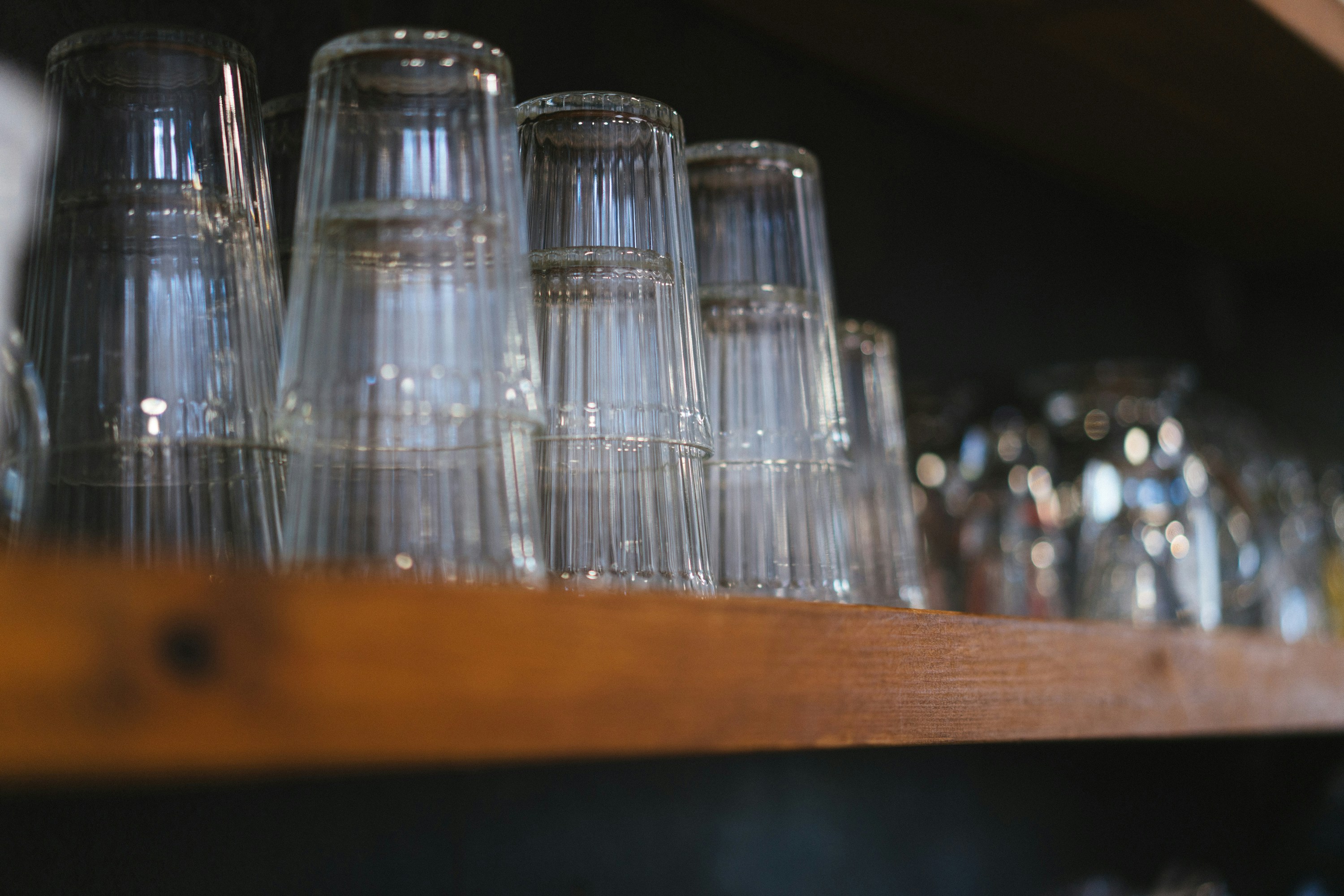 assorted beer glasses on a backlit bar shelf - accessories for beer