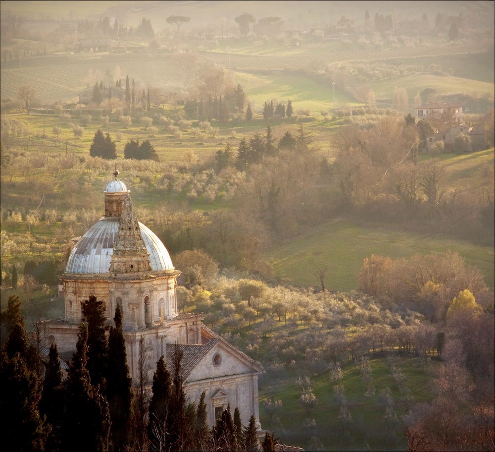 a church in the middle of a green field