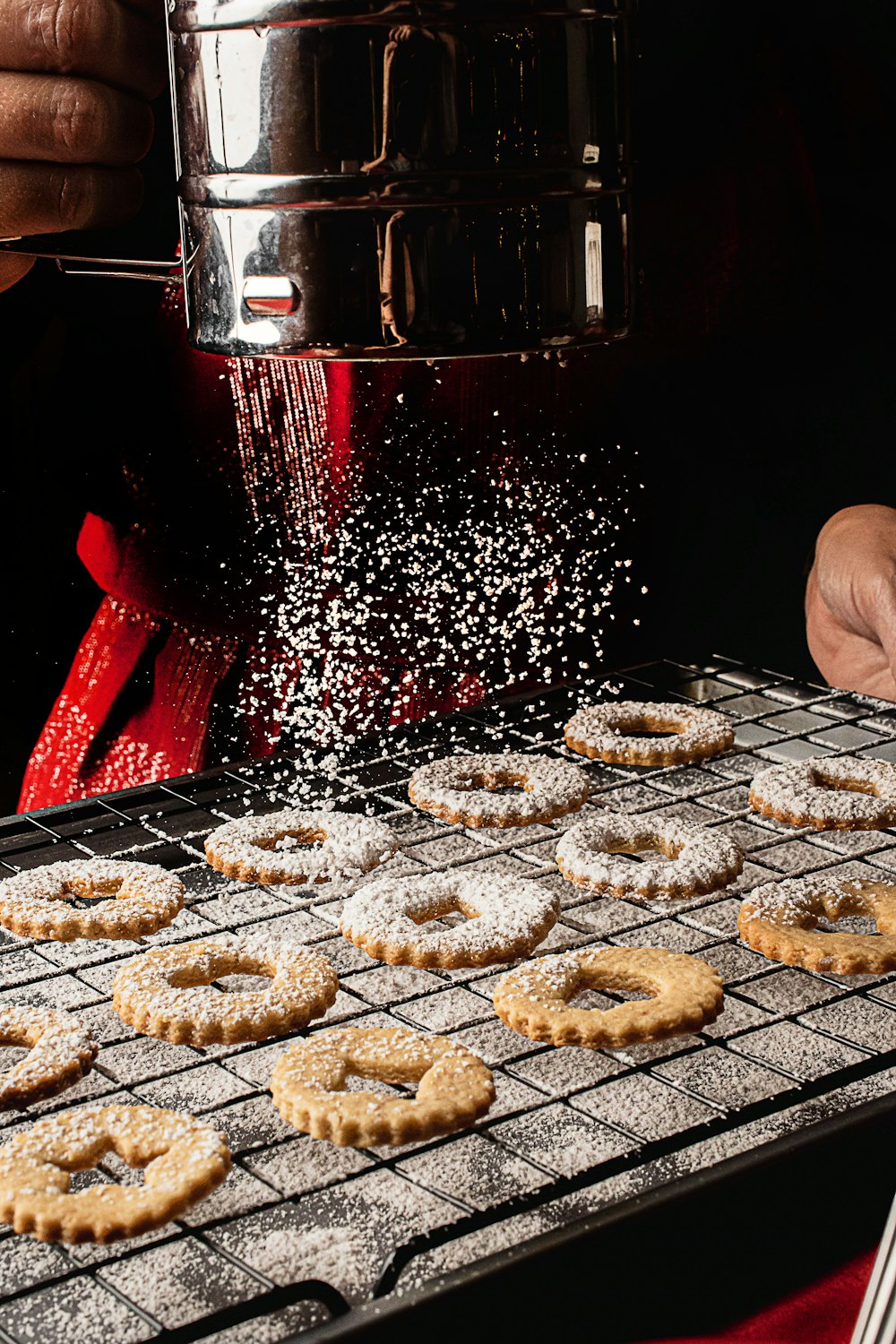 a person is sprinkling sugar on some cookies