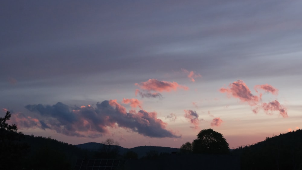 a sunset with pink clouds in the sky