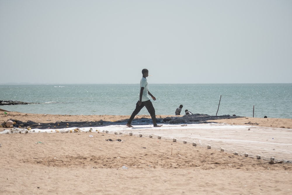 a person walking on a beach near the ocean