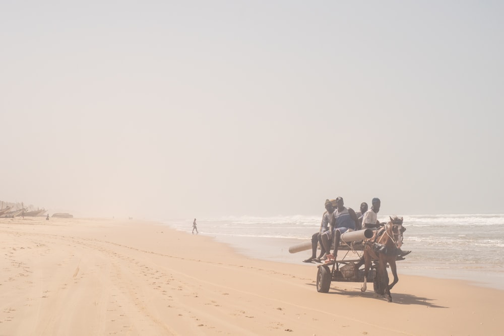 a group of people riding on the back of a horse drawn carriage