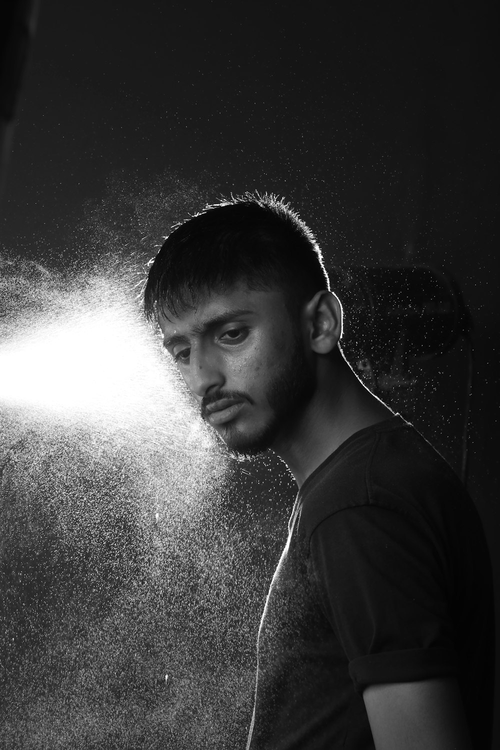 a man standing under a light in a room