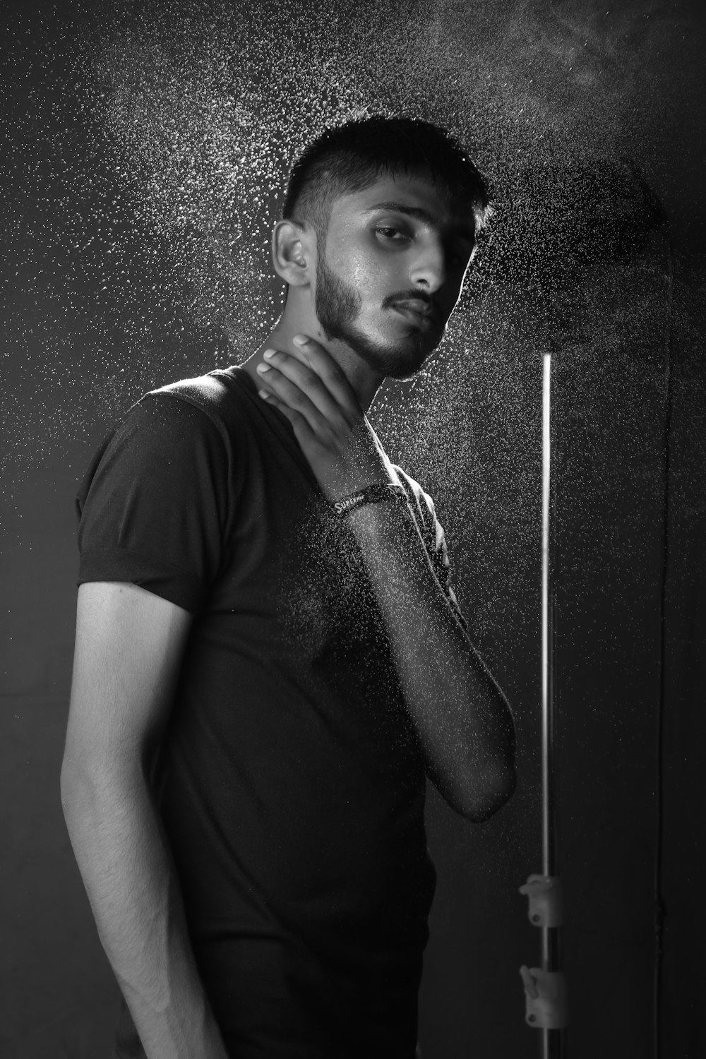 a man standing under a shower of water