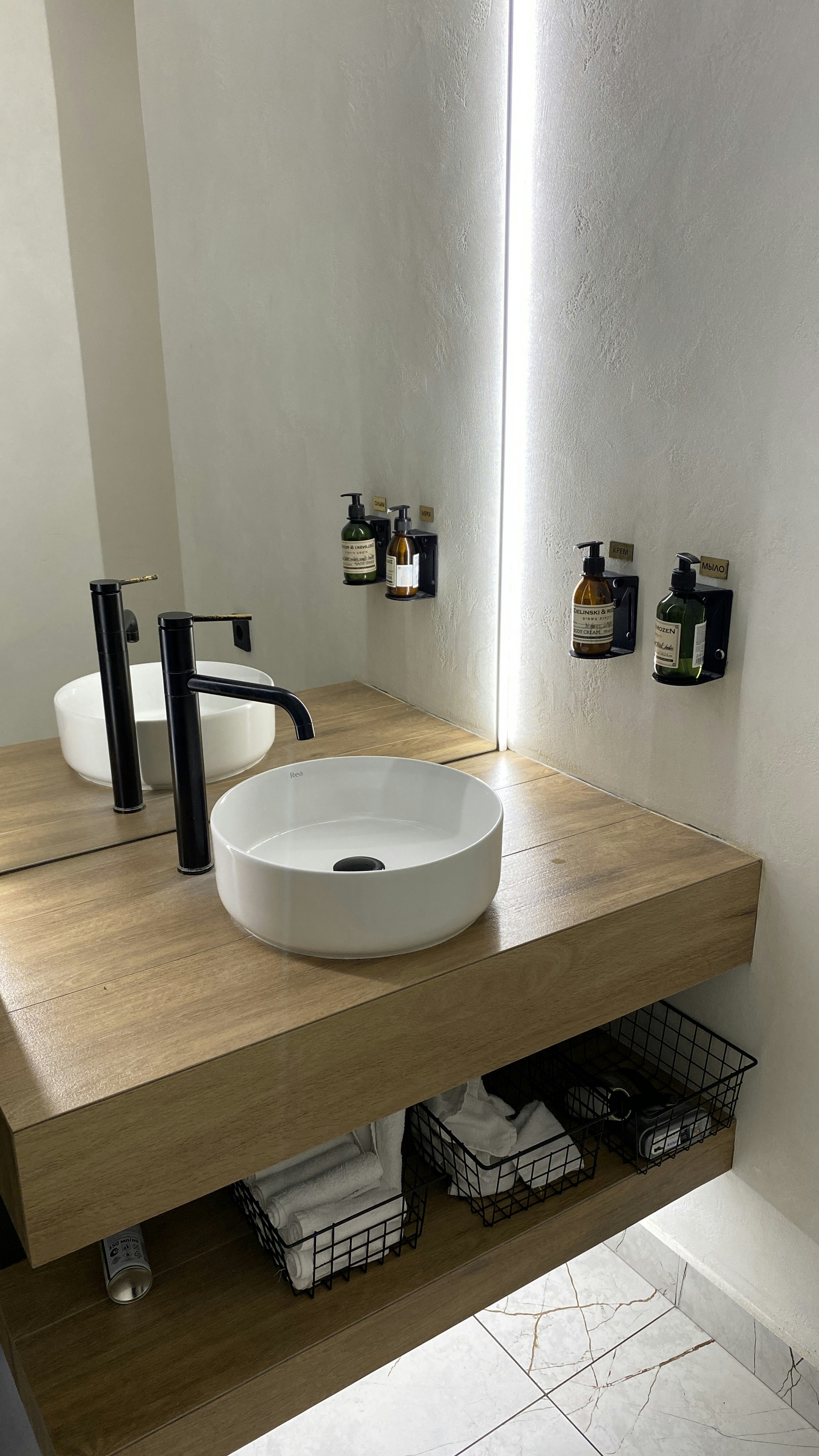 Minimalist bathroom with vessel sink and wall-mounted cabinetry