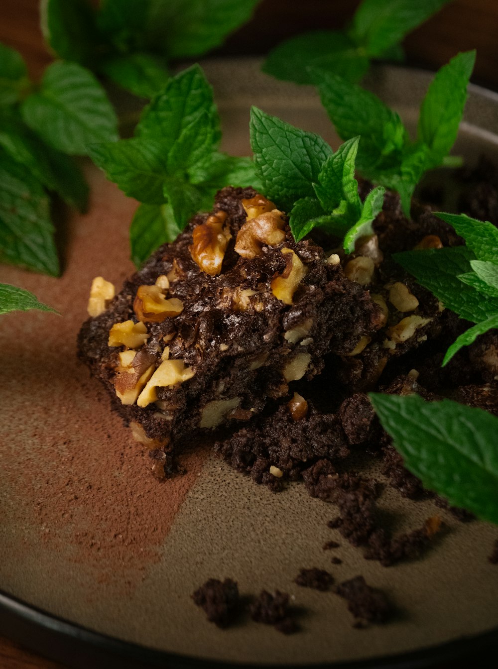 a piece of cake on a plate with mint leaves