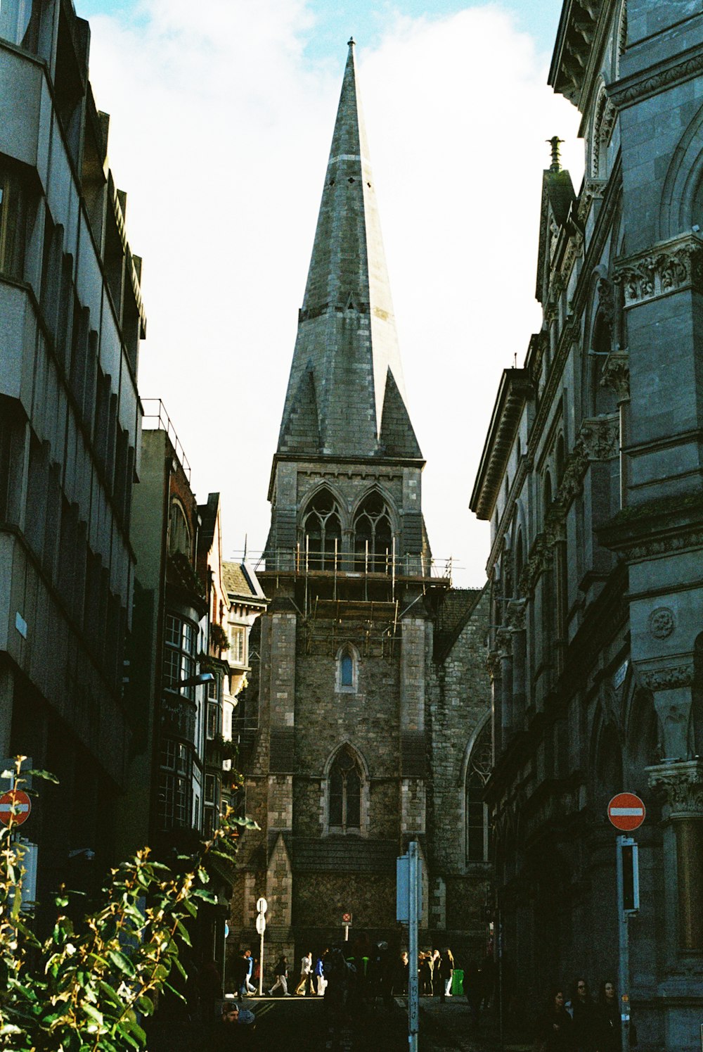 an old church with a steeple in the middle of a city