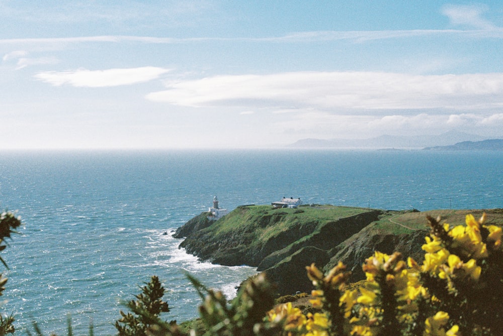 a view of the ocean with a lighthouse in the distance