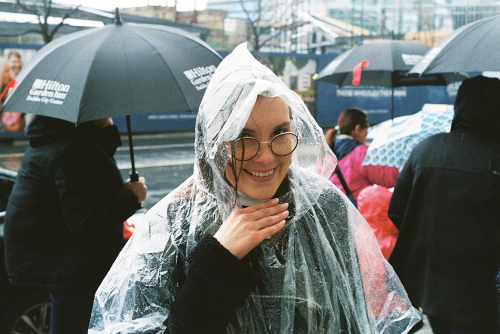 a woman wearing a raincoat and holding an umbrella