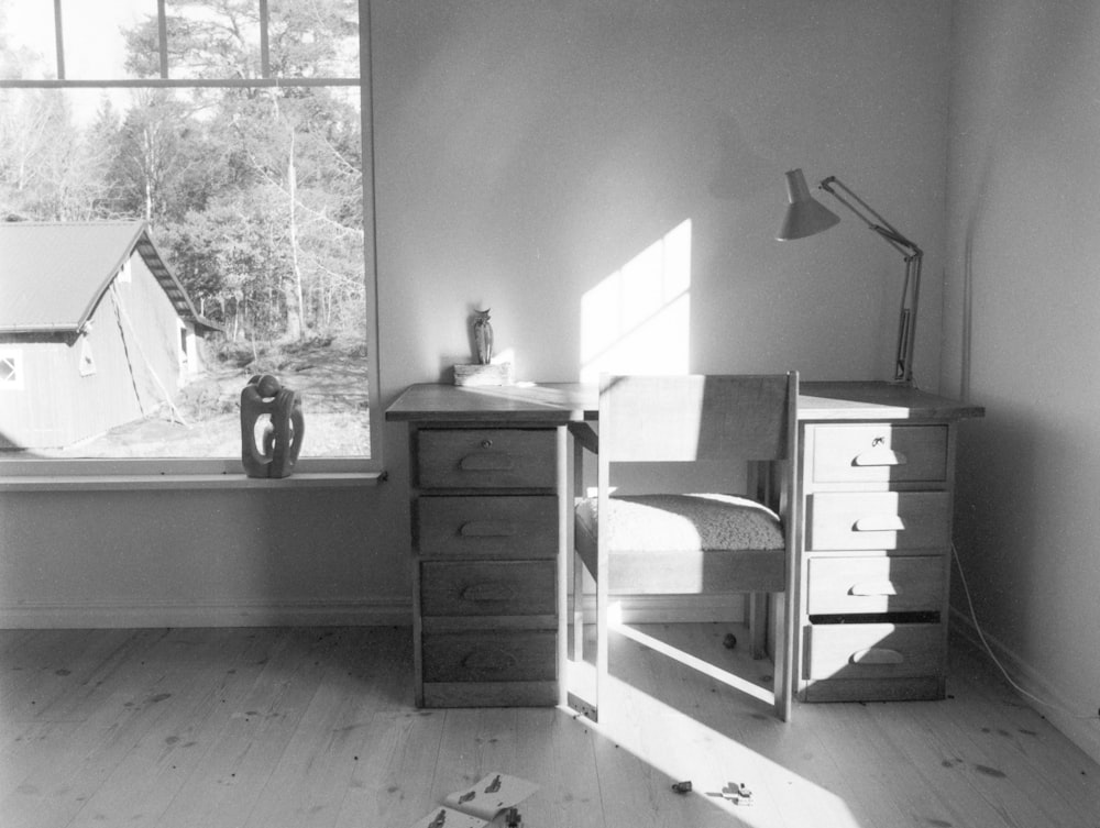 a black and white photo of a bedroom with a window