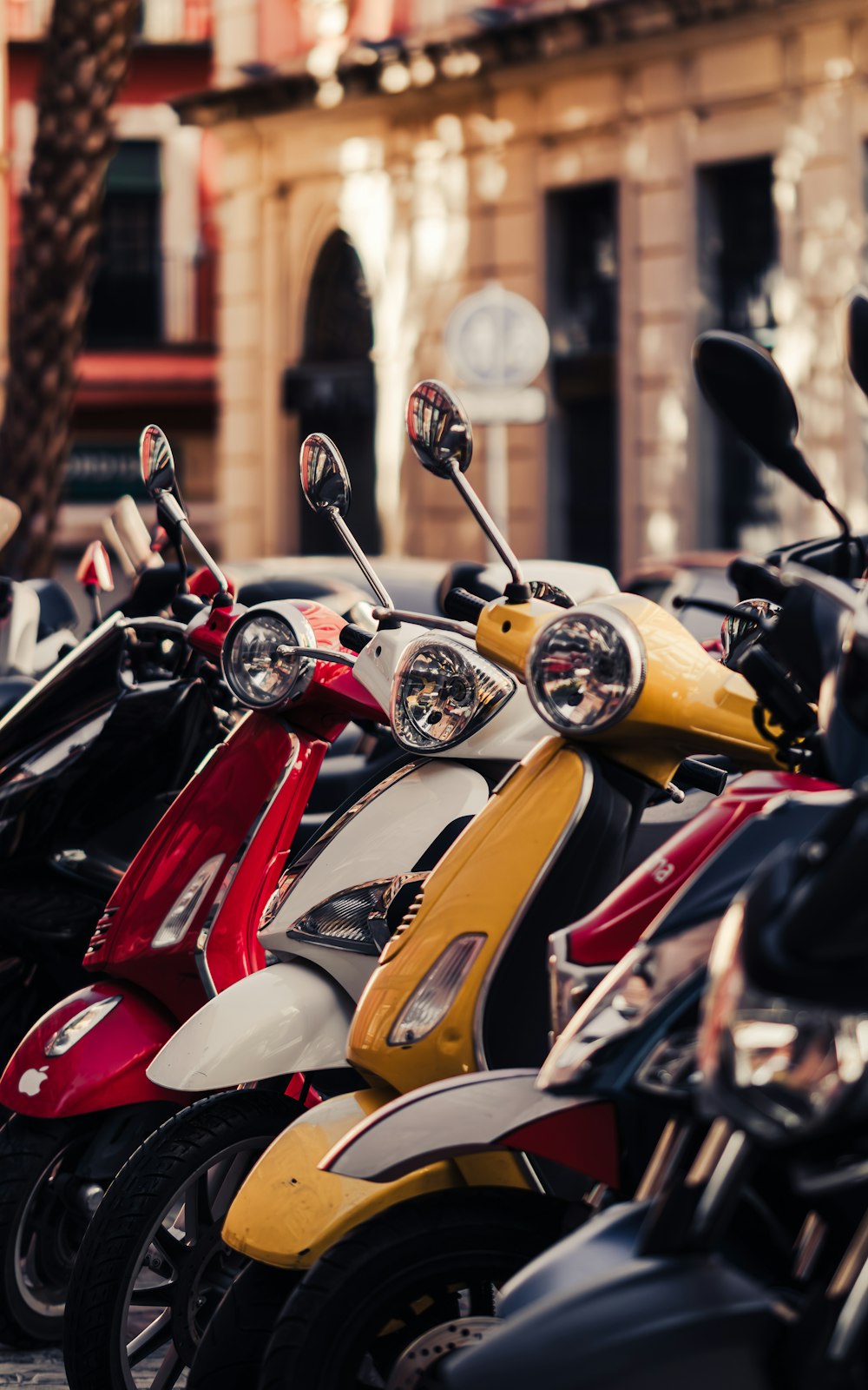 a row of motor scooters parked next to each other