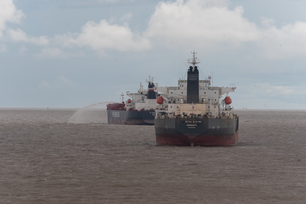 two large ships in the middle of a body of water