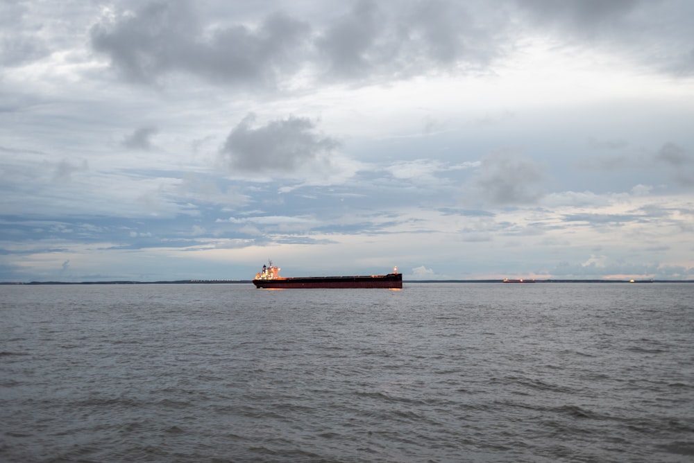 a large cargo ship floating on top of a large body of water