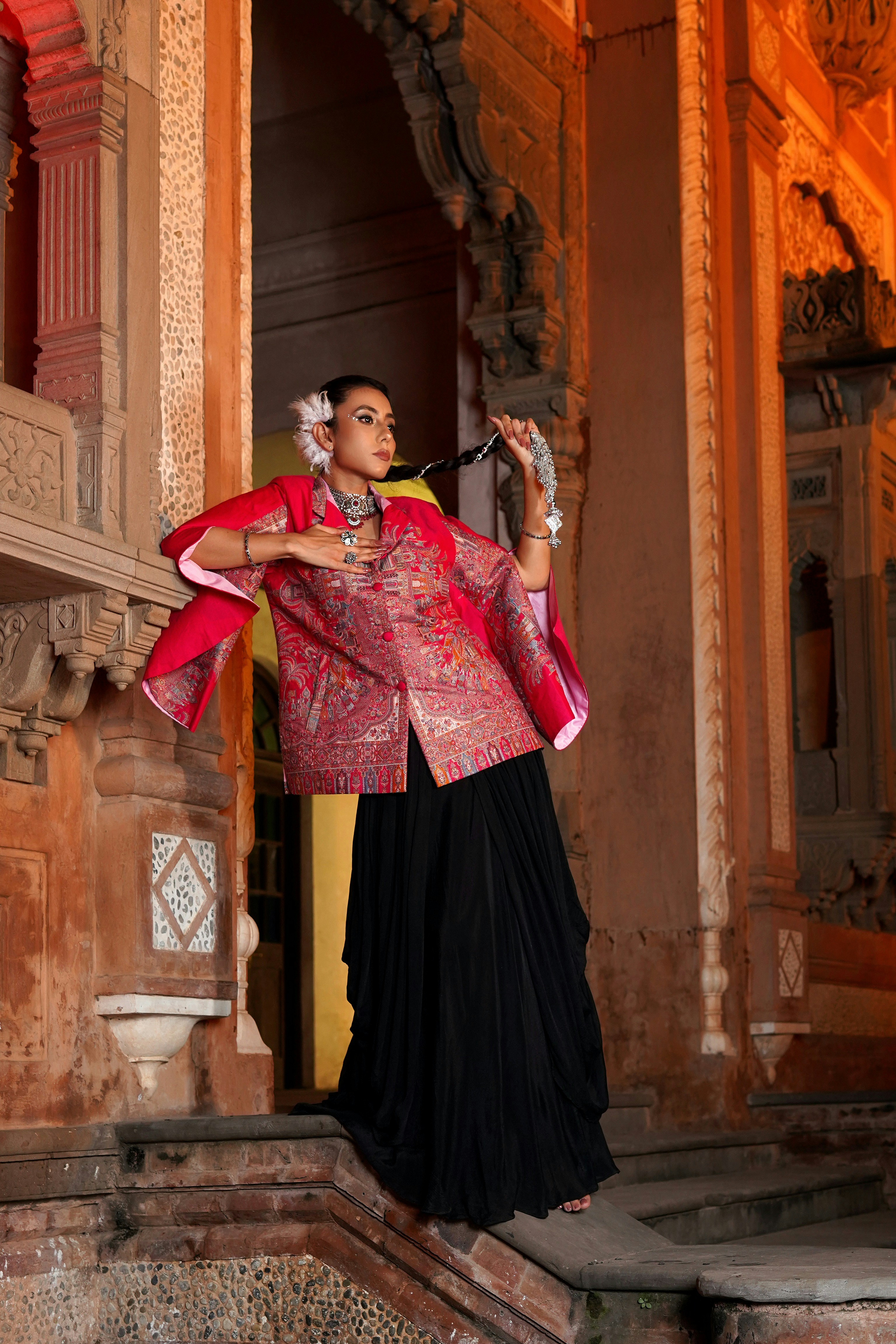 a woman in a red jacket and black skirt