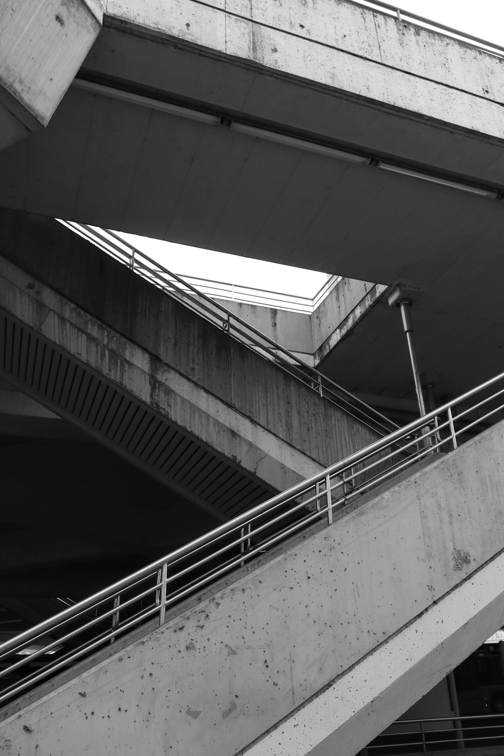 a man riding a skateboard down a metal hand rail