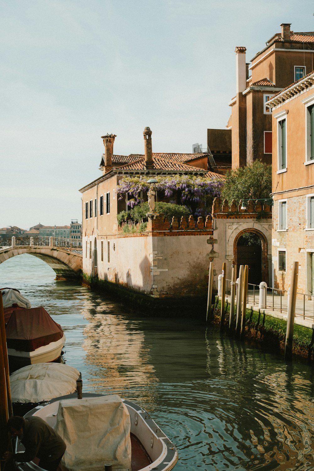 a boat traveling down a river next to a building