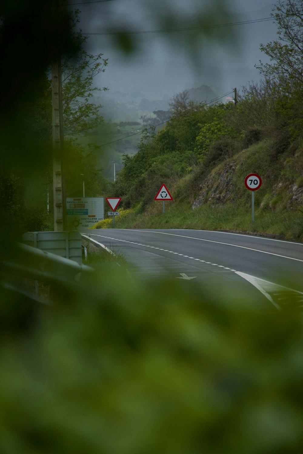 a road with a few signs on the side of it