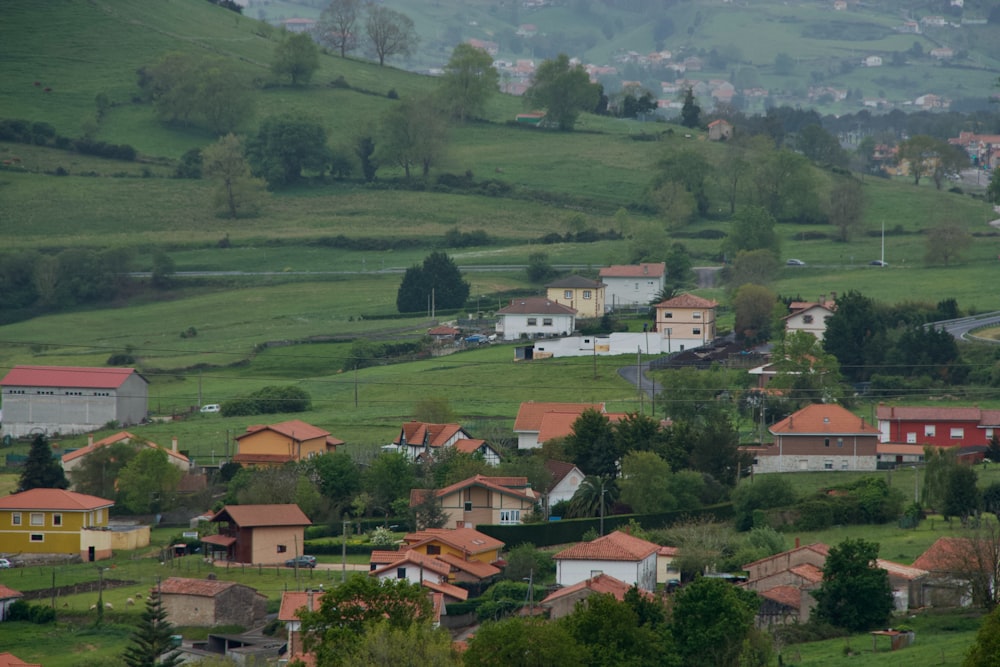a small village in the middle of a lush green hillside