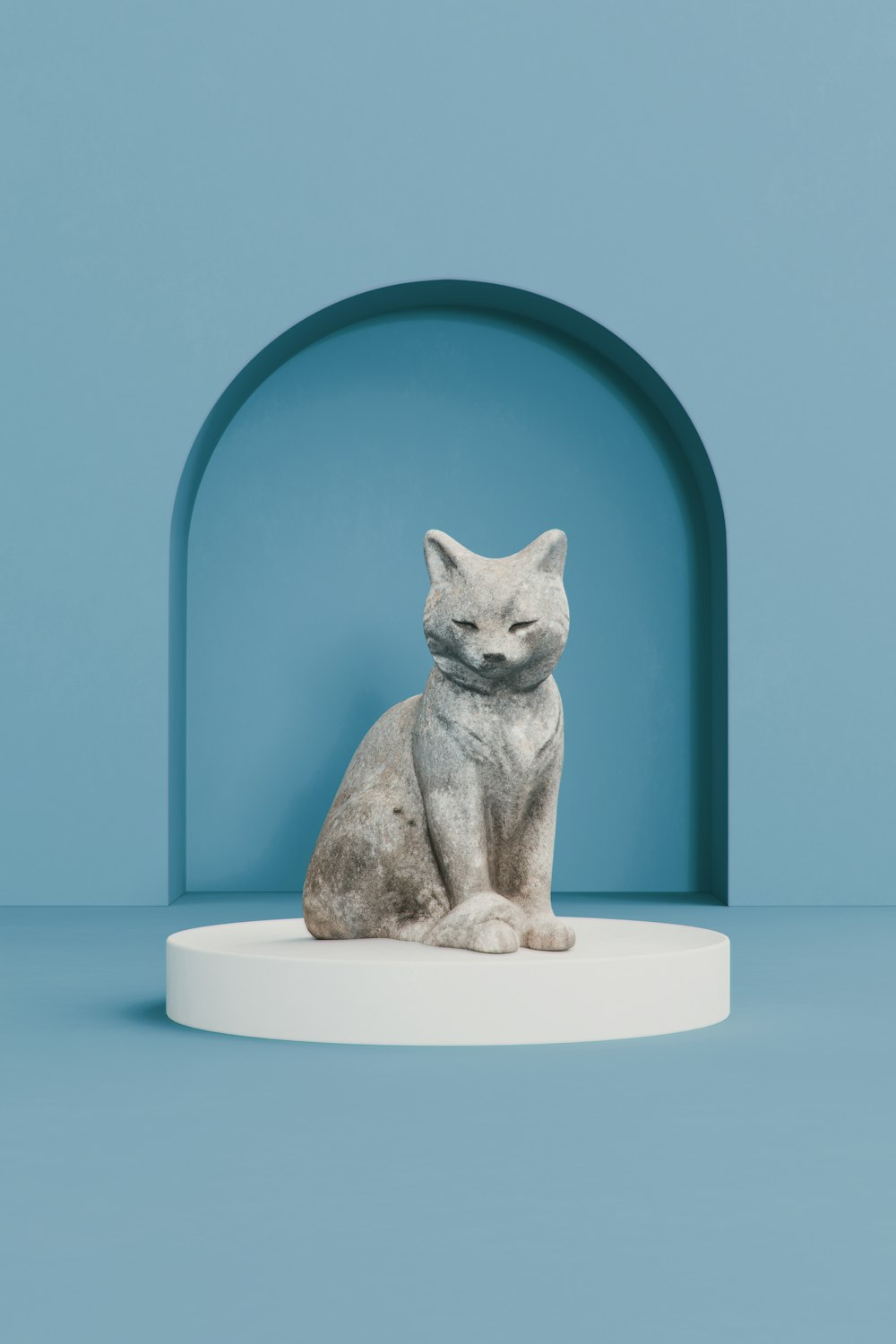a cat statue sitting on top of a white base