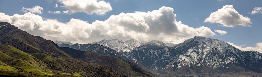 a view of a mountain range with clouds in the sky