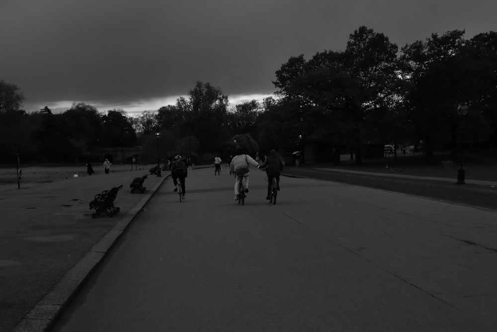 a group of people riding bikes down a street