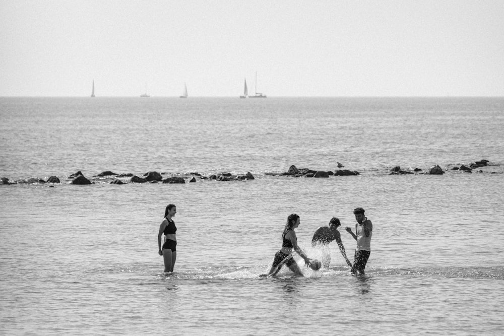 a group of people standing in the water