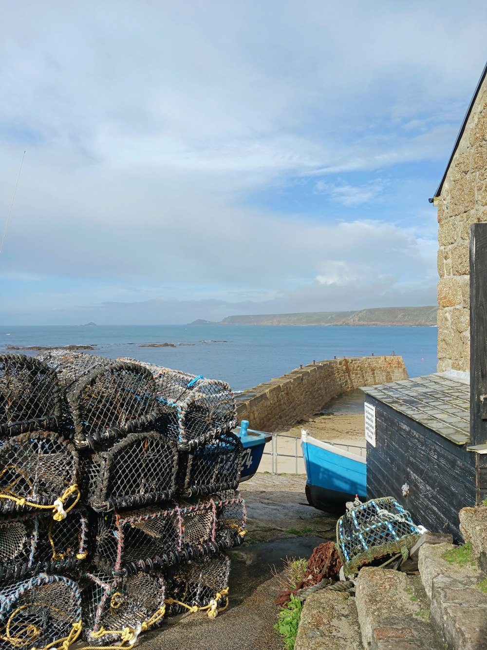 a pile of lobster traps sitting next to a building