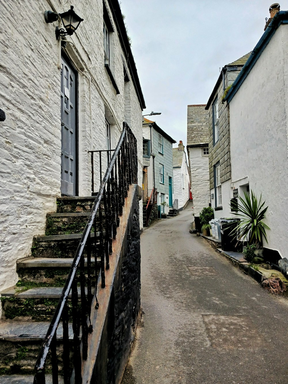 a narrow street with steps leading up to a door