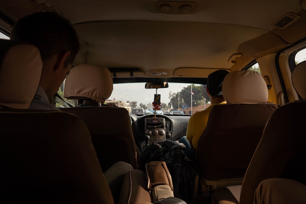 a group of people sitting in the back of a car