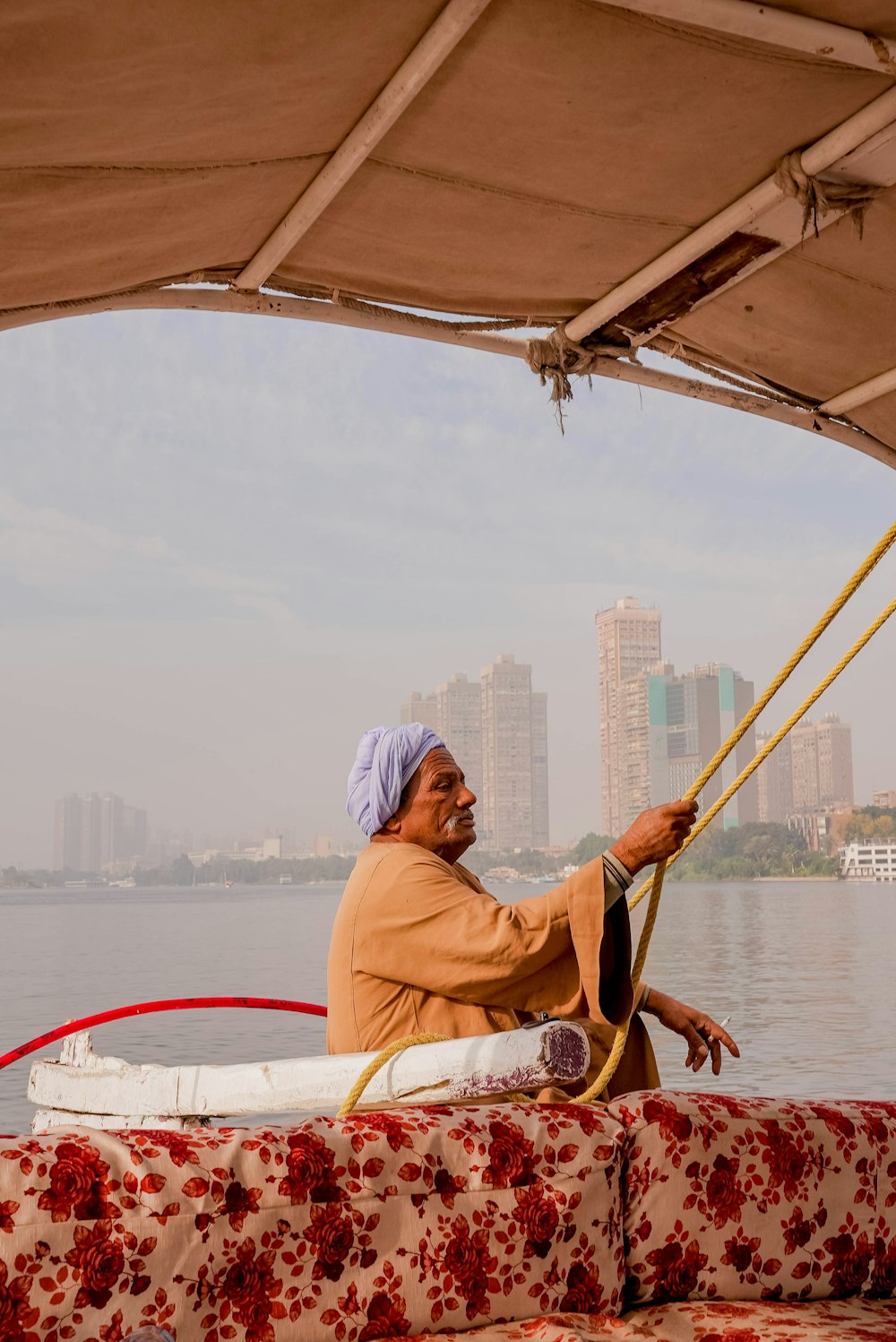 a man sitting on a boat in the water