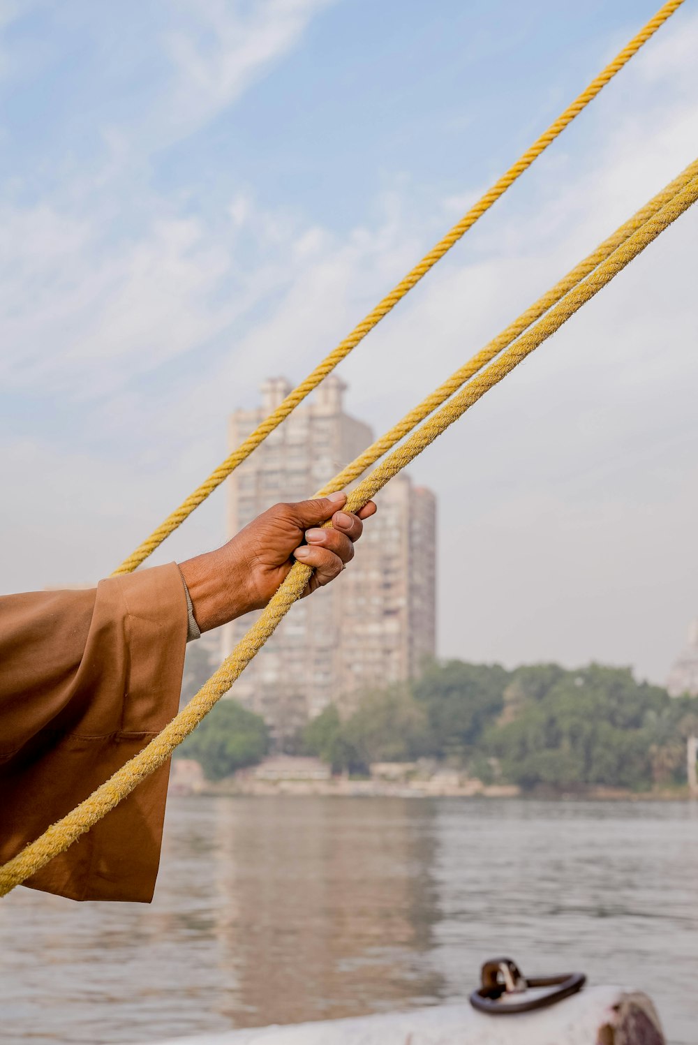 a man is holding a rope on a boat