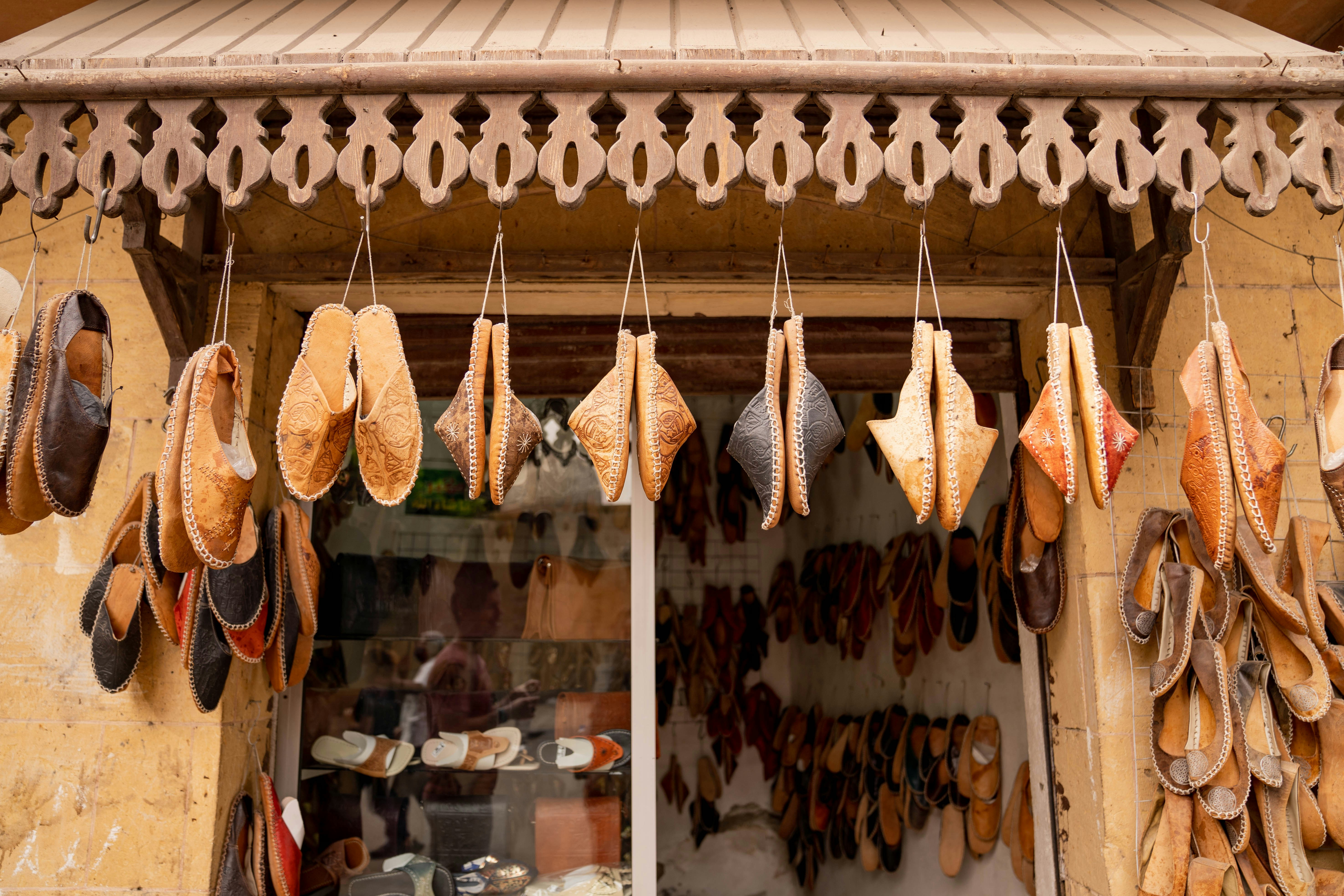 A store front with lots of hats hanging from it's windows