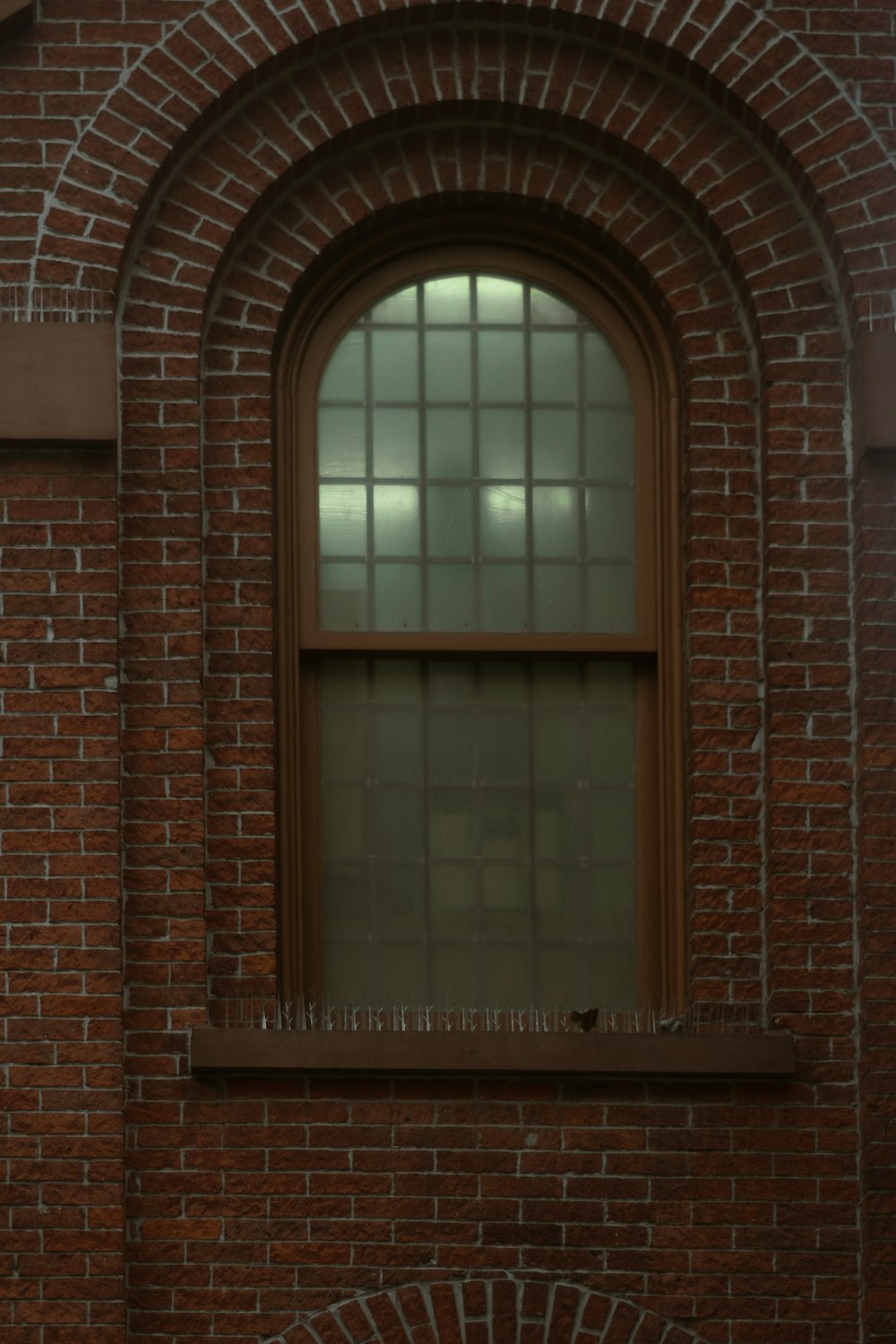 a brick building with a window and a clock