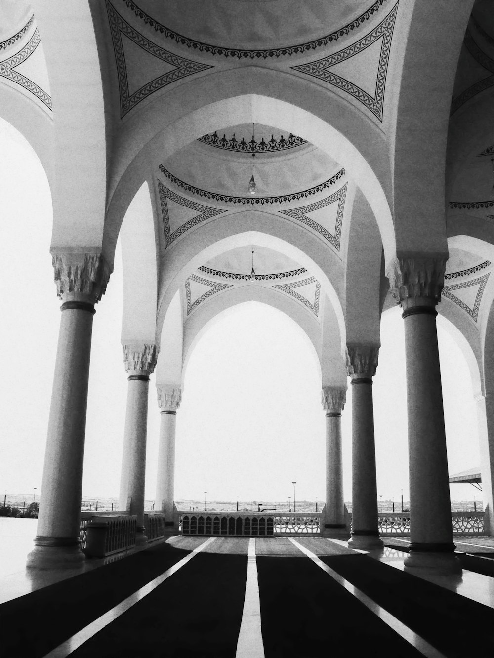 a black and white photo of arches and pillars