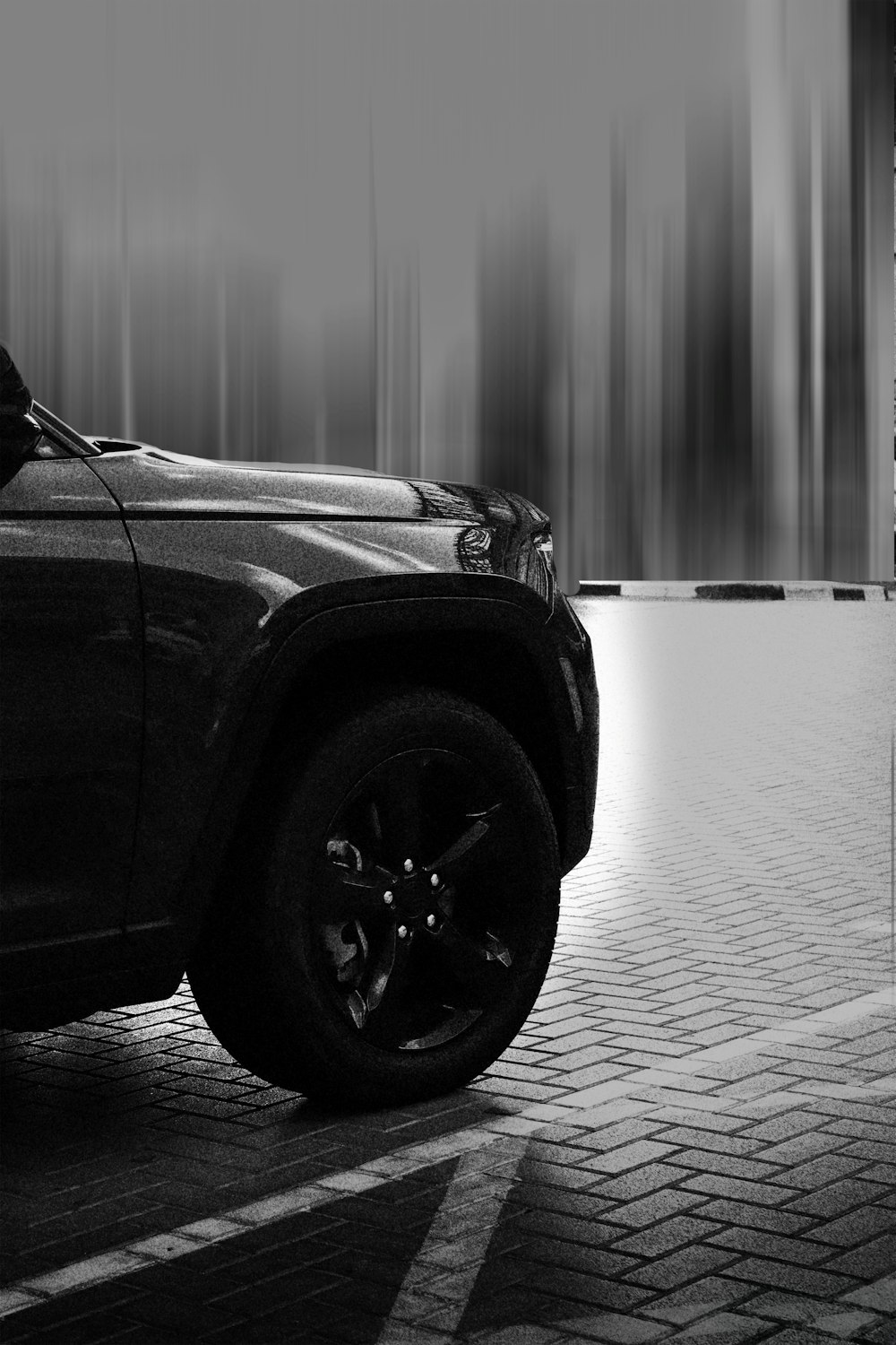 a black and white photo of a truck parked in a parking lot