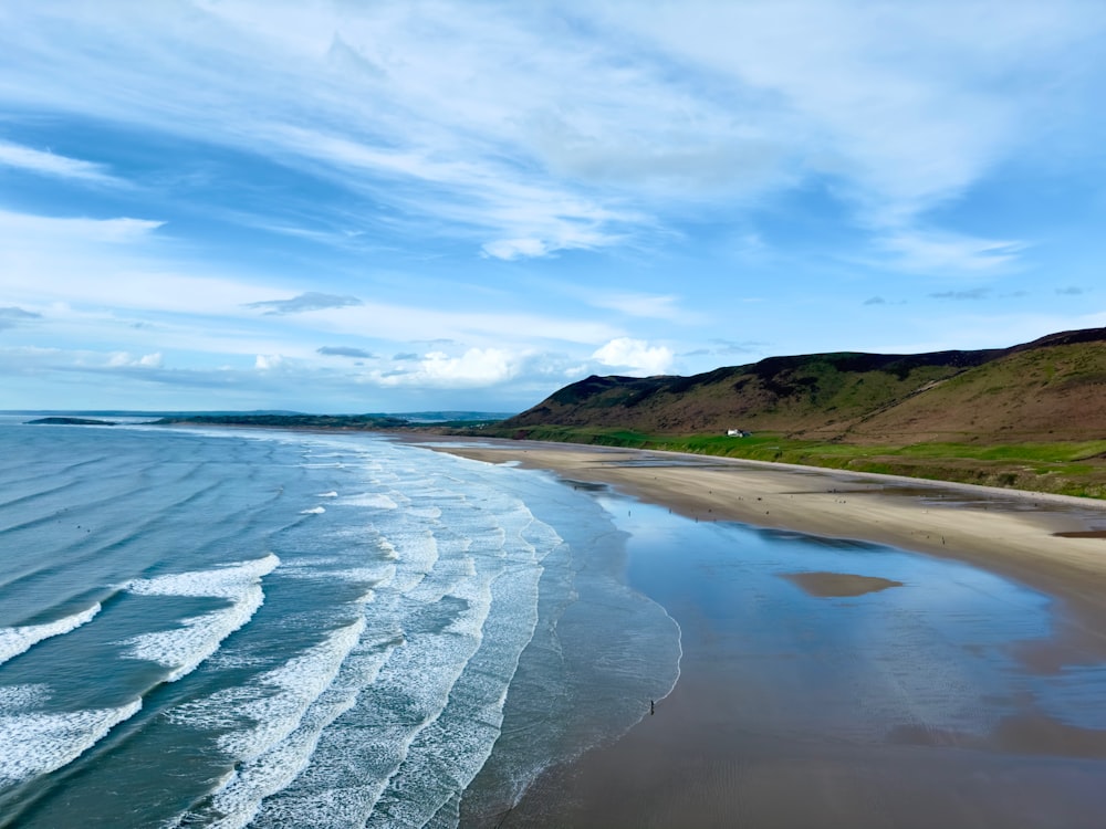 a view of a beach with a hill in the background