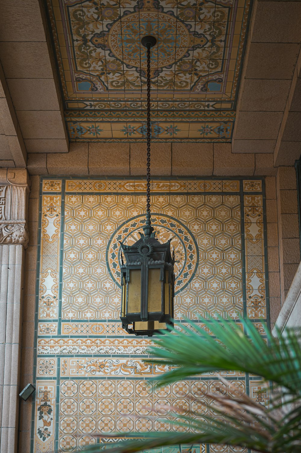 a lamp hanging from the ceiling of a building