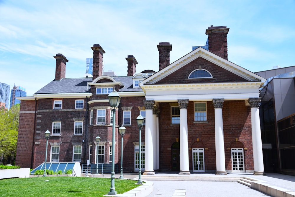 a large brick building with columns and a clock tower