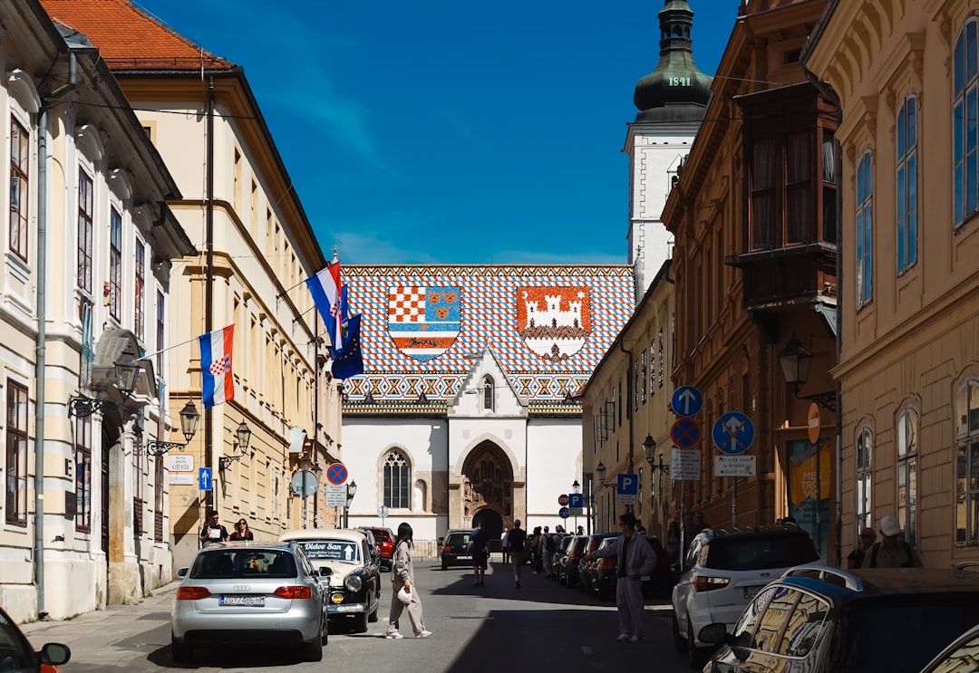 a street with cars parked on both sides of it,