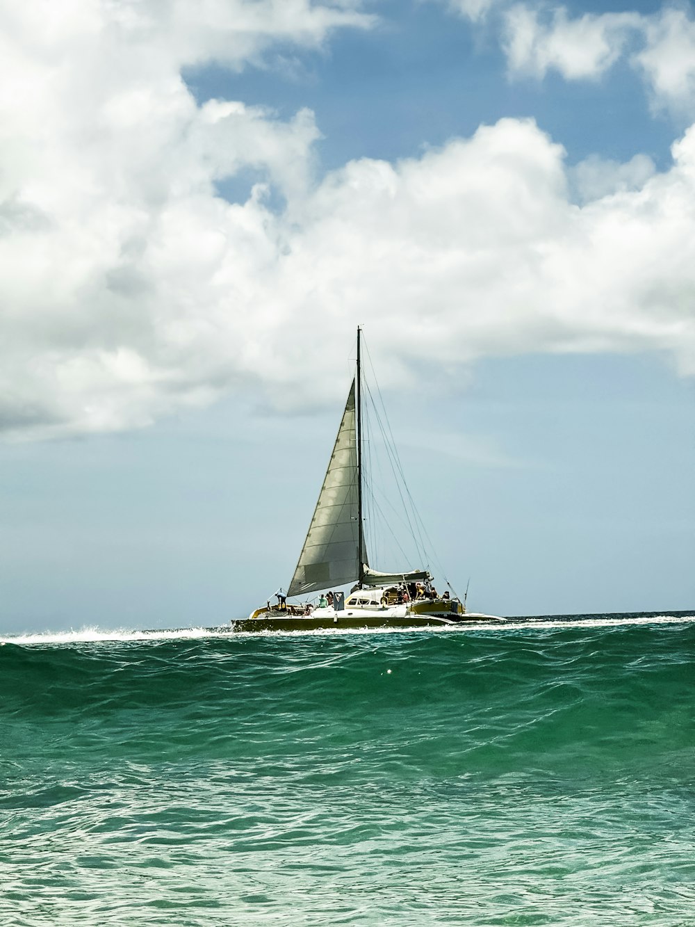 a sailboat in the middle of the ocean