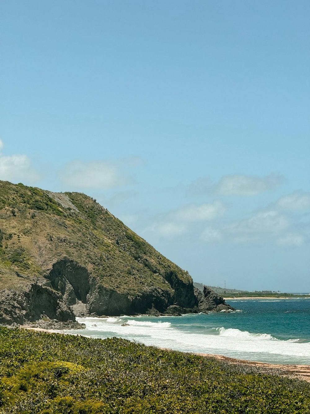 a man riding a surfboard on top of a sandy beach