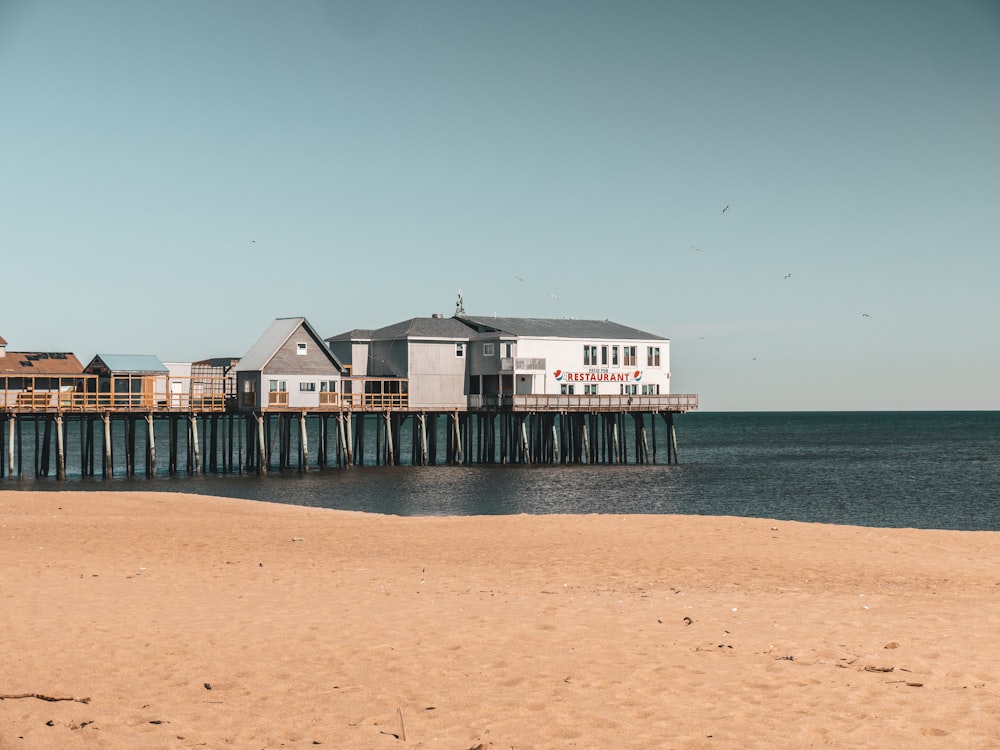 a beach with a pier and houses on it
