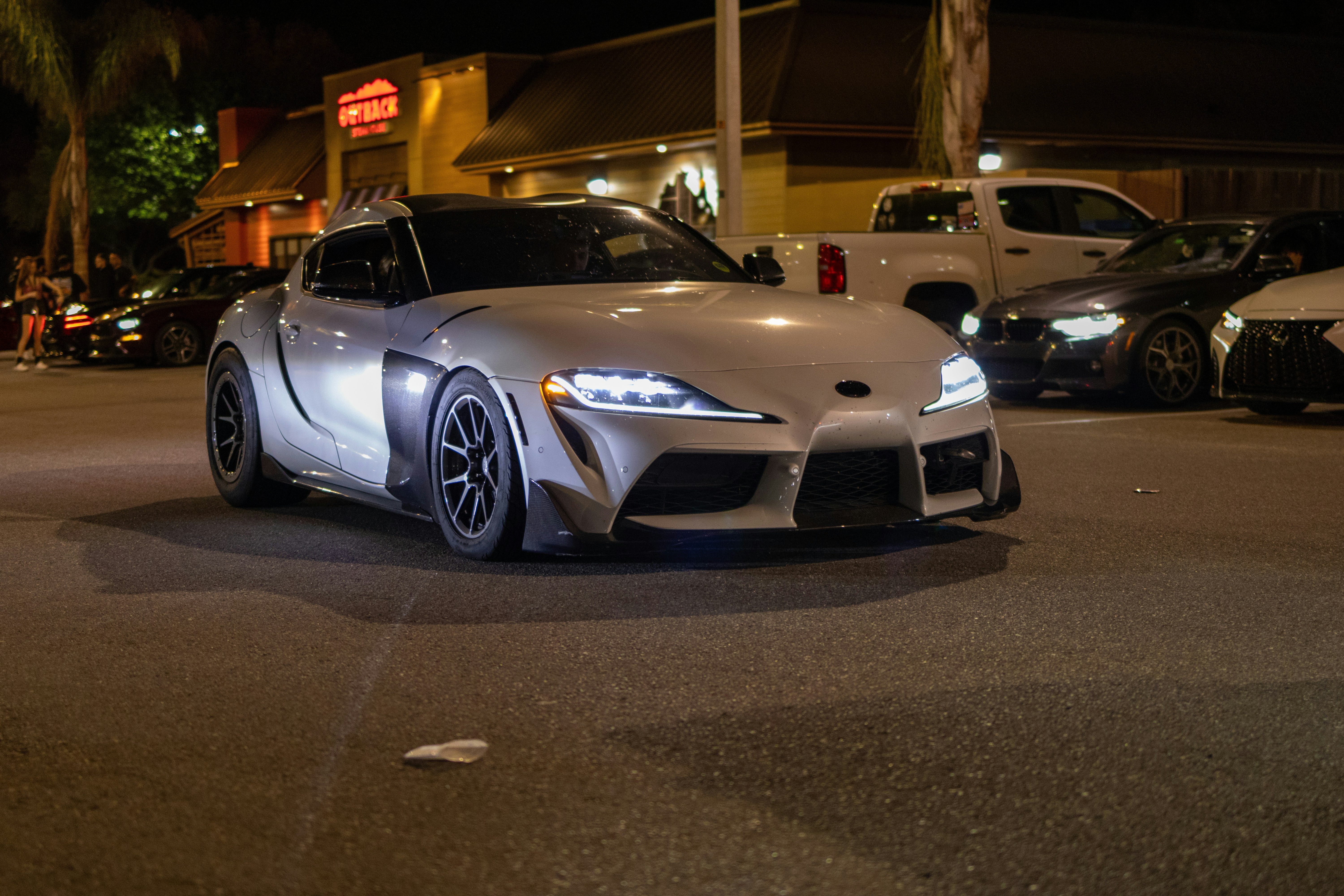 A white sports car parked on the side of the road photo – Free ...